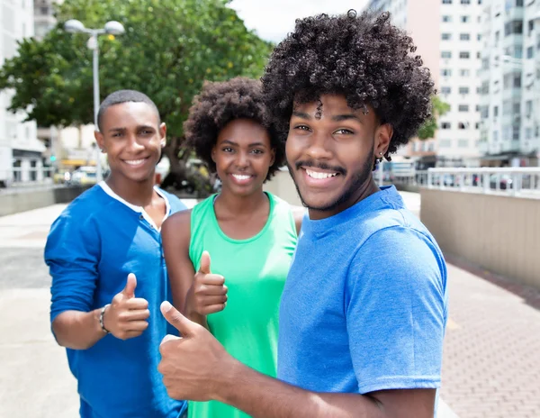 Group of african american young adults showing thumb