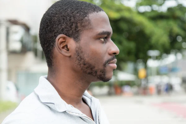 African man with beard looking sideways