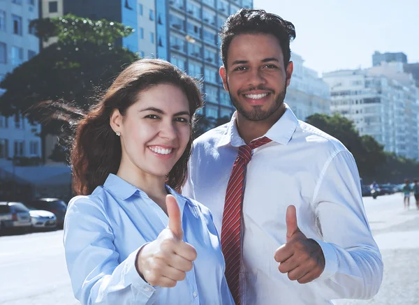 Business team showing thumb up in cool cinema look