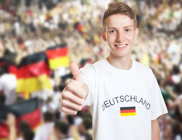 Handsome german fan showing thumb with other fans