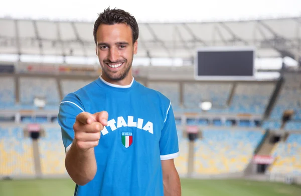 Italian sports fan pointing at camera at soccer stadium
