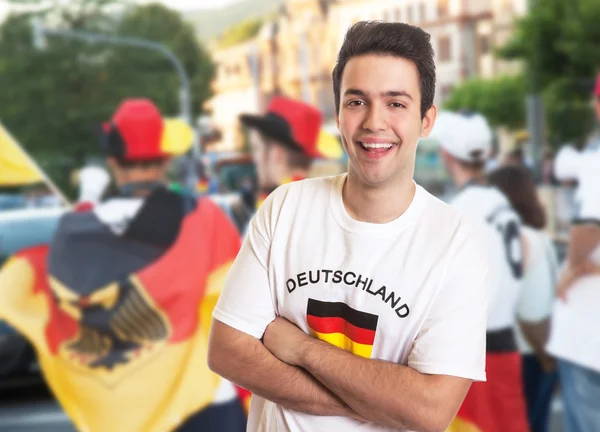 Cool fan in german jersey with other fans
