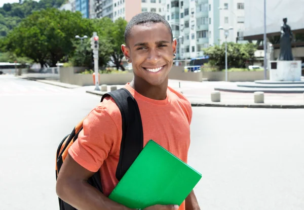 Laughing african american male student in city