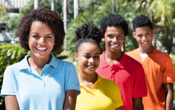 Group of four happy latin american young adult in line