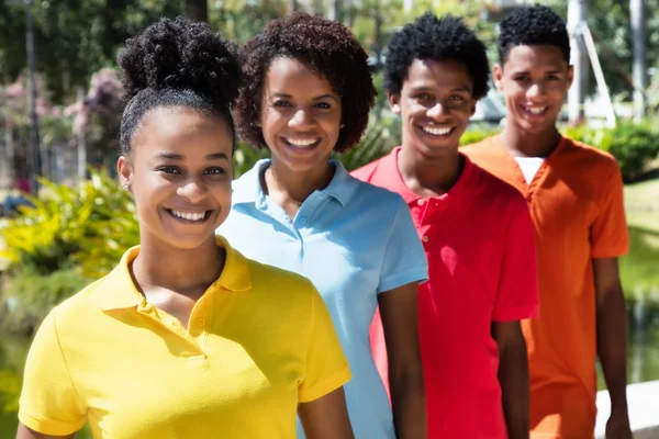 Group of four latin american young adult in line