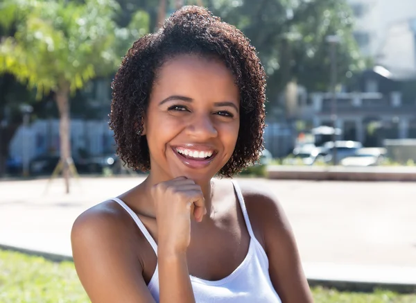 Laughing latin american woman outdoor in the summer