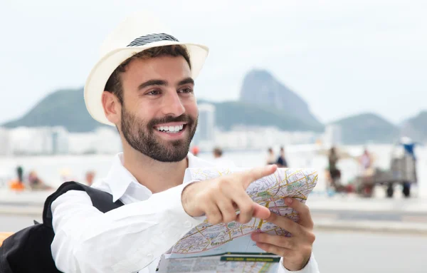 Pointing tourist with map at Rio de Janeiro