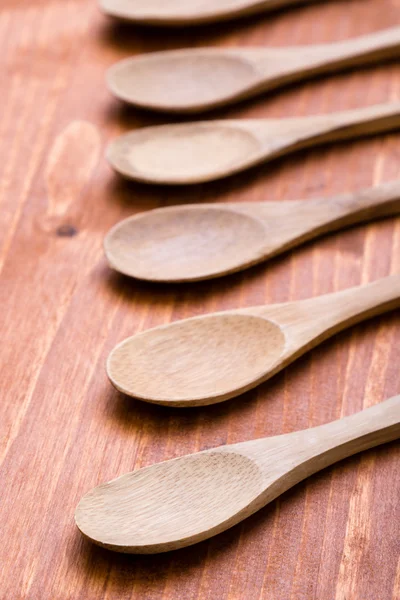 Wooden spoons on wooden table