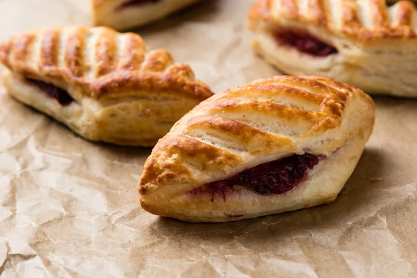 Puff pastry with jam on paper