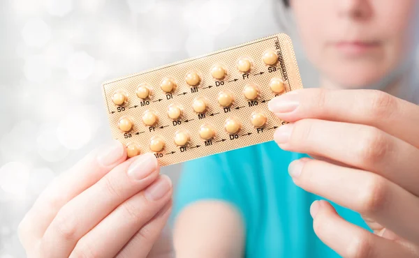 Young woman with birth control pills