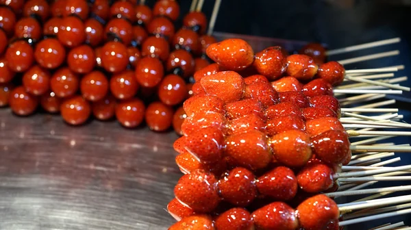 Strawberry and tomato glazed on stick in Taiwan night market