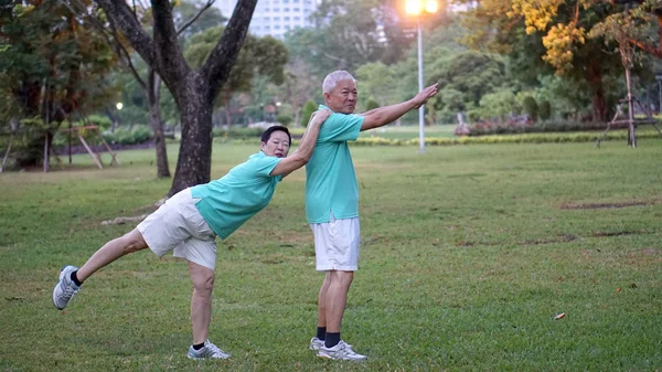 Asian senior couple happy and enjoy life style exercising in the park