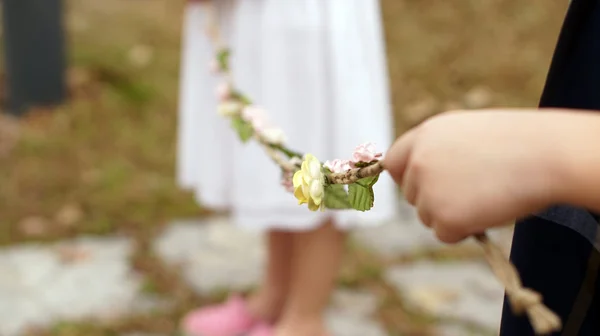 Hand holding a rope of flower for wedding