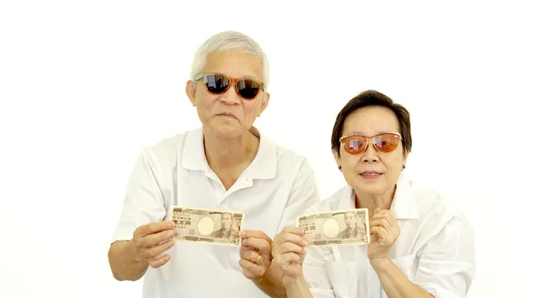 Happy rich cool asian senior showing cash money japanese Yen