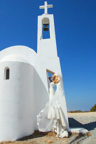 Beautiful bride in a wedding dress in greece with a long veil