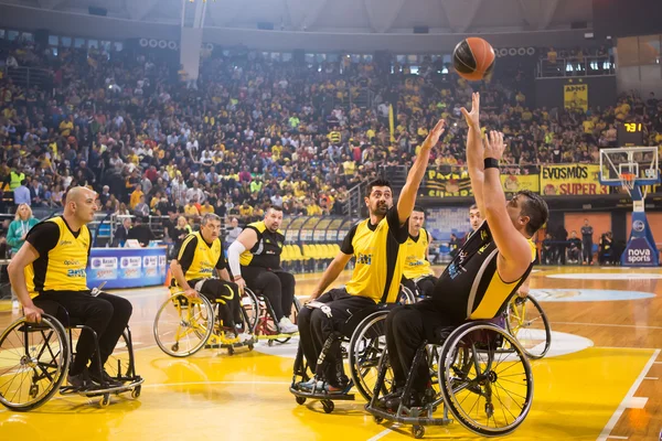 Unidentified people play a friendly game of wheelchair basketbal