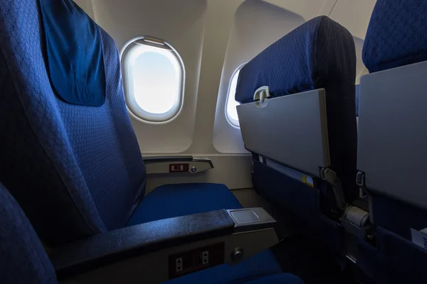 Airplane seat and window inside an aircraft.