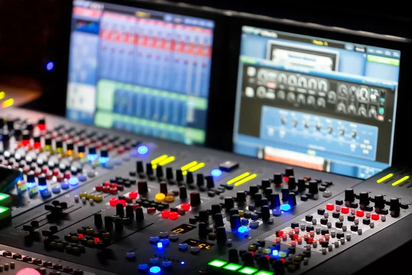 A mixing console, or audio mixer,shallow dof