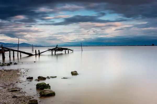 Long exposure of magic sunrise and wooden pier. Photographed usi