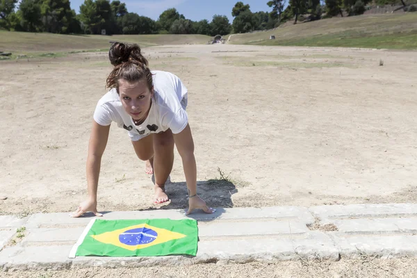 Girl ready to run with the Brazilian flag for the next Olympics