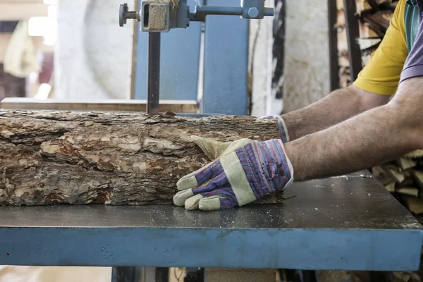 Craftsmen cut a piece of wood at a woodworking factory in Greece