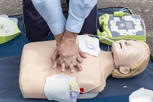 The instructor showing CPR on training doll. Free First Aid