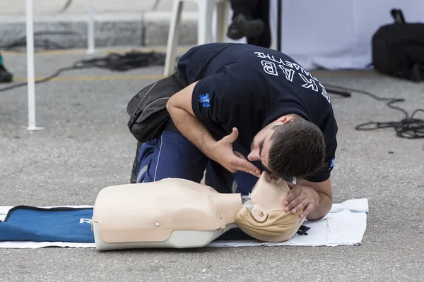 The instructor showing CPR on training doll. Free First Aid