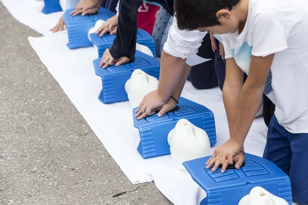 The instructor showing CPR on training doll. Free First Aid