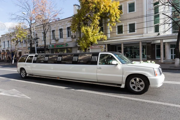 White limousine with flowers at the city street in Krasnodar, Ru
