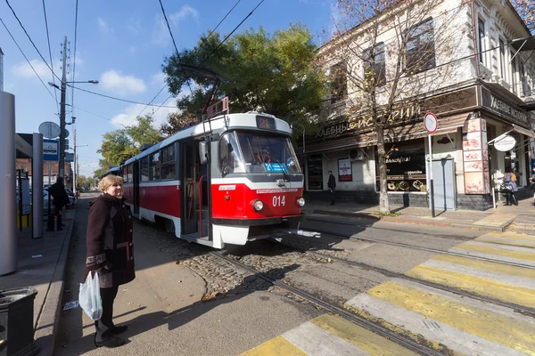 Retro tram arrives at the stop of public transport in Krasnodar,