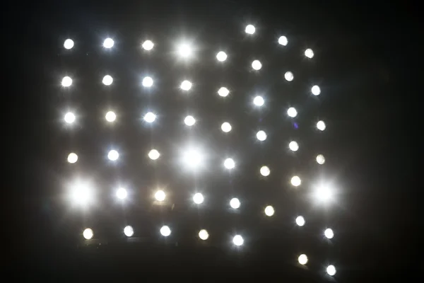 Bright white and yellow Stadium lights with fog