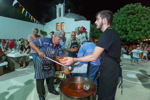 People giving traditional Greek food at the big yearly festival