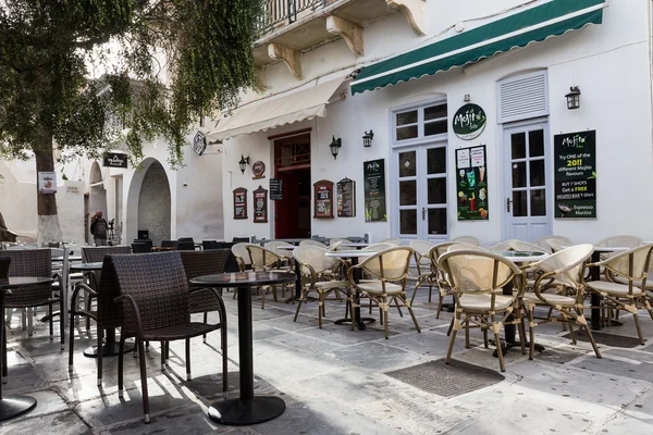 Empty tables in greek coffee shop on the street of mediterranea