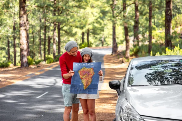 Couple traveling by car in the forest