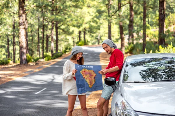 Couple traveling by car in the forest