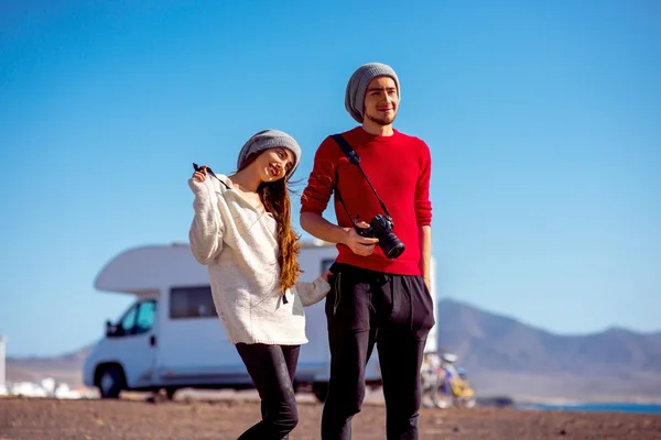 Couple traveling by camping trailer