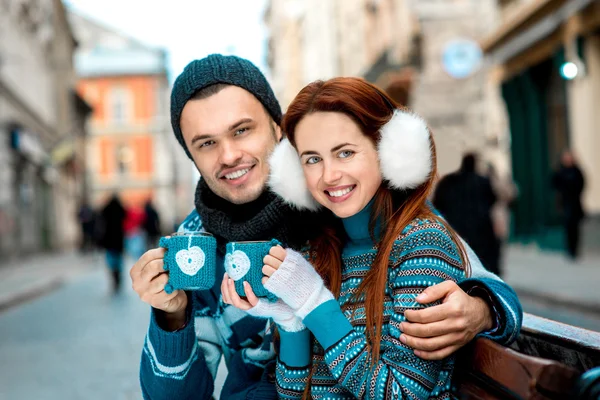 Young couple with coffee in winter outside