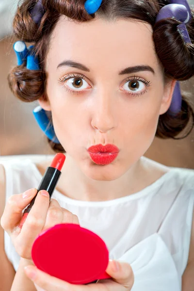 Smiling woman with hair curlers