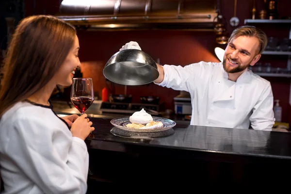 Chef cook serving dessert to the client