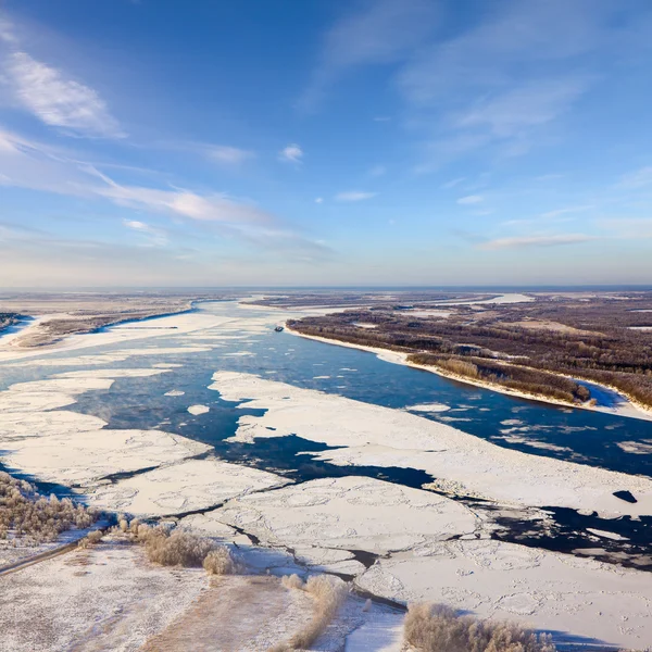 Floating ice floes are drifting on the great river