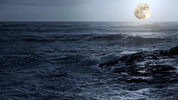 Arising full moon over sea