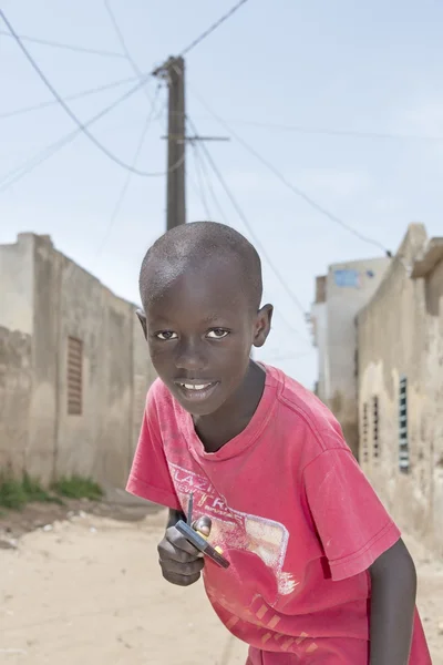 Editorial caption, Thiaroye, Senegal, Africa, July 30, 2014, Unidentified boy standing in the street, popular district of Guinaw Rails