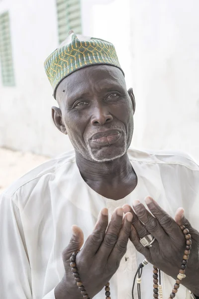 Thiaroye, Senegal, Africa, July 18, 2014, Unidentified Muslim man praying in front of the Grand Mosque