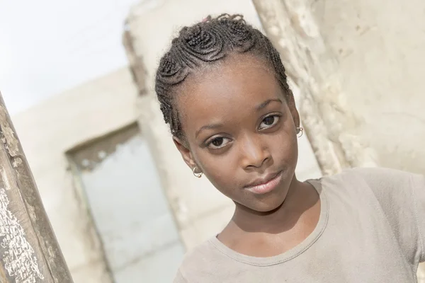 Thiaroye, Senegal, Africa, July 30, 2014, Unidentified girl standing at the door of her house, popular district of Guinaw Rails