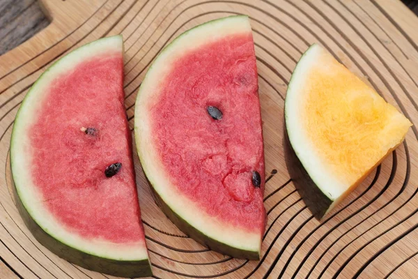 Watermelon red is delicious on wood background.
