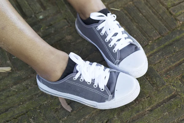 Gray sneakers with model lifestyle