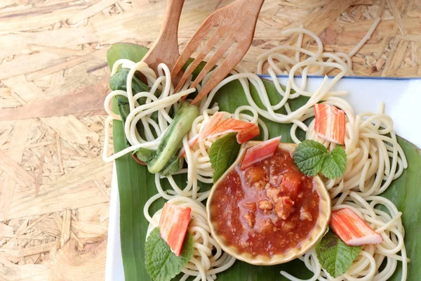 Pasta spaghetti with crab sticks and sauce.