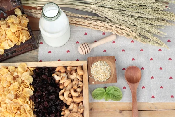 Corn flake with currant dried fruit ,cashew nuts and milk.