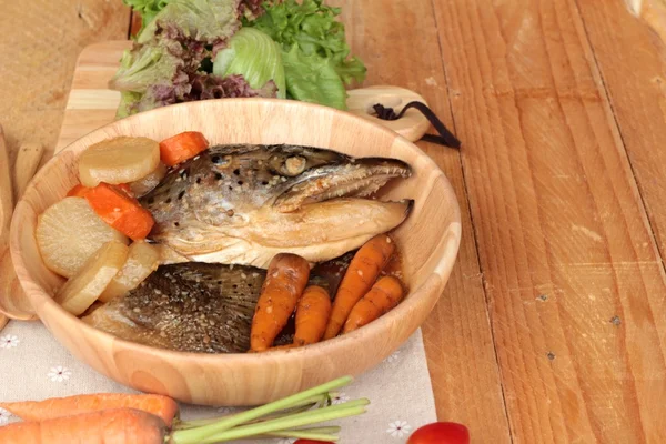 Salmon head cooked of tari yaki sauce with fresh vegetables.