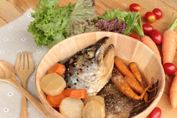 Salmon head cooked of tari yaki sauce with fresh vegetables.